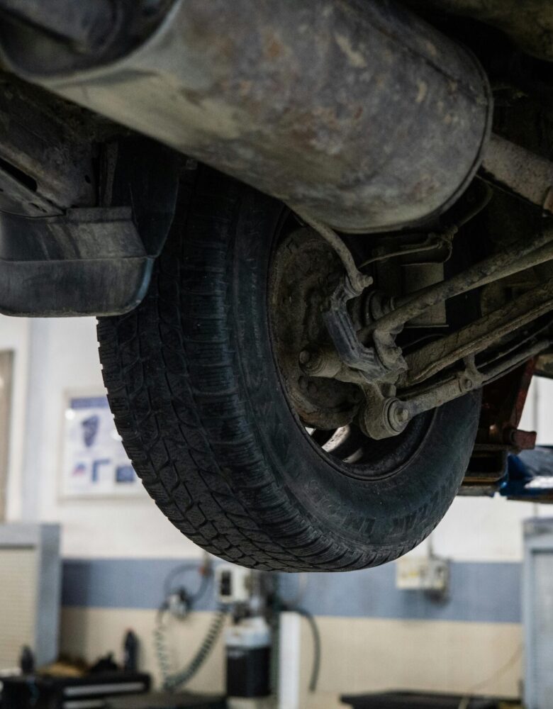 Close-up of car's undercarriage in a service station for repair and maintenance.